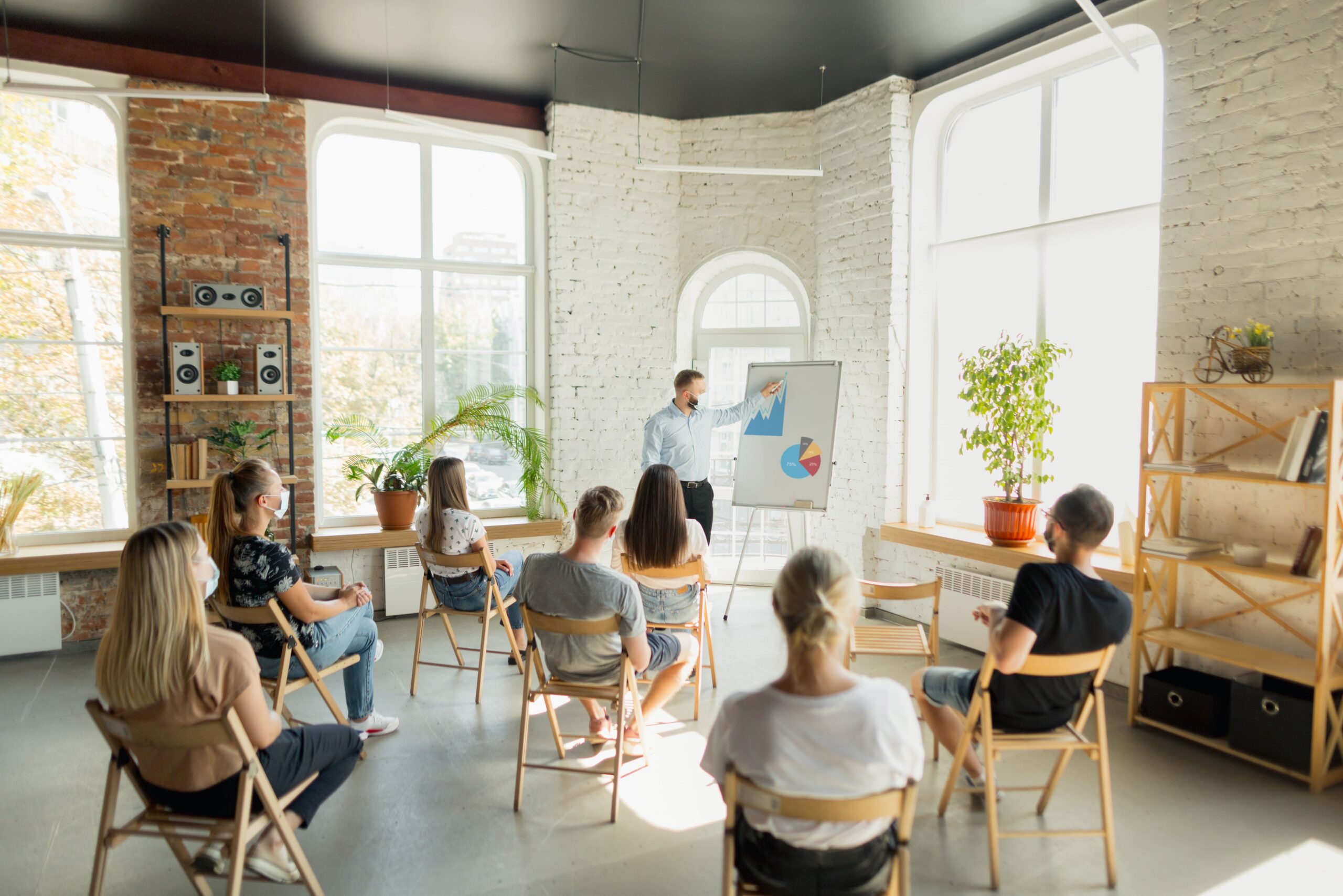 male-speaker-giving-presentation-in-hall-at-university-workshop-audience-or-conference-hall-2